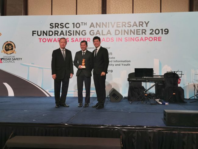 Mr Poh receiving the Gold Donor Token of Appreciation from Mr Bernard Tay [L-R : Mr Bernard Tay (Chairman, Singapore Road Safety Council), Mr Poh Kay Leong, and Mr Ng Kok Cheong (Council Member)]